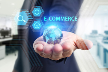 The concept of business, technology, the Internet and the network. A young entrepreneur working on a virtual screen of the future and sees the inscription: E-commerce