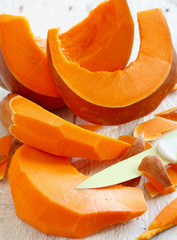 Pumpkin slices on a wooden background