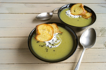 vegetarian cream soup of green vegetables. on a black background