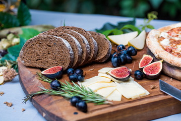 Dinner still life with rye bread, figs and pizza
