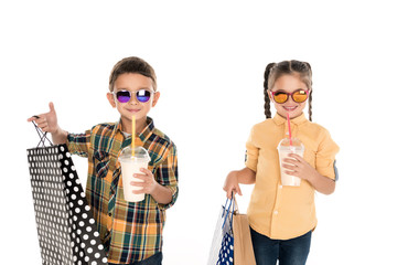 Obraz premium siblings with shopping bags and milkshakes