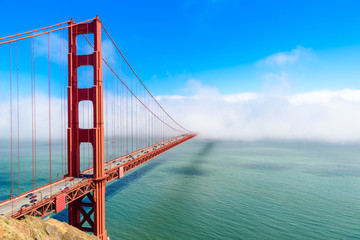 Golden Gate Bridge in clouds on a beautiful summer day  - Panoramic view from Battery Spencer - California, USA