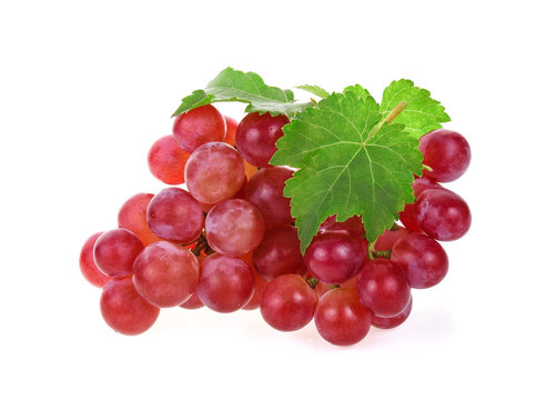 Ripe red grape with leaves on white background