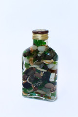 bottle with sea pebbles