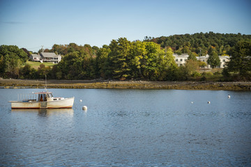 Fototapeta na wymiar Fishing boats anchored in the bay in Maine, USA