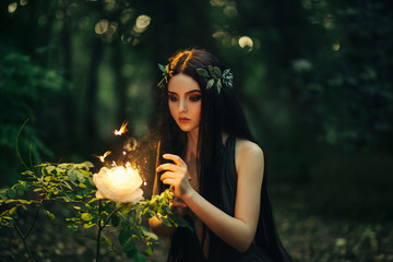 A fabulous, forest nymph with long hair found a flaming, fiery flower, with which little...