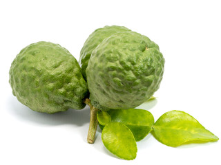 close up group of fresh bergamot with green leaves isolated on white background. benefits of bergamot for beauty and health concept