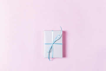 Top view of a gift box with a blue ribbon