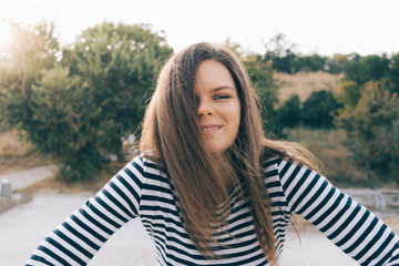 Young smiling woman in a striped T-shirt
