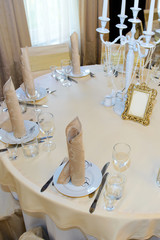 Classic table setting in the restaurant. Luxurious dining table for the holiday feast. Table with food served. 