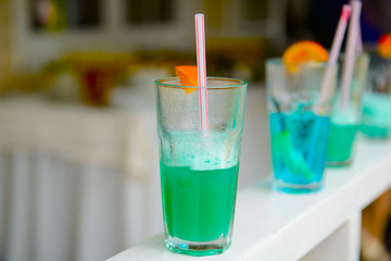 Fresh colored juices of the fruit in the glasses. Refreshing beverages at the party. Fruit cocktails for guests. 
