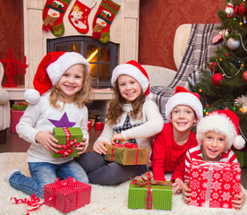 Group of four children with presents on Christmas party