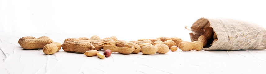 Peanuts in nutshell on white background and peeled peanuts.