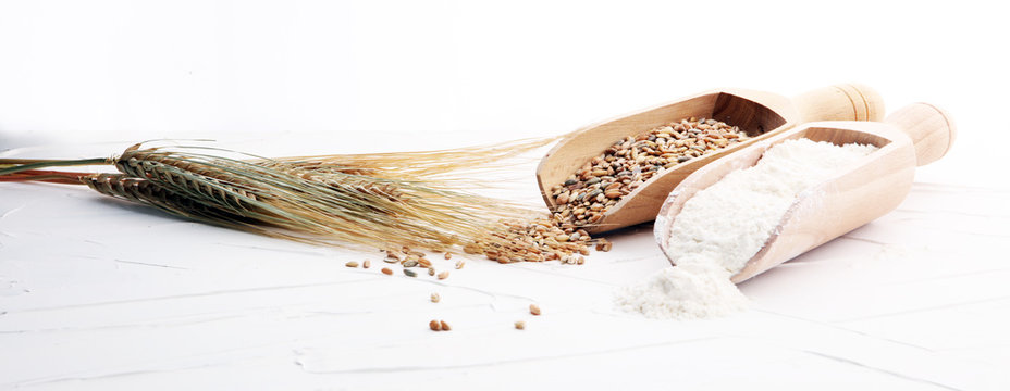 Whole Grain Wheat Flour And Seeds On White Background.