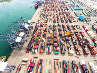 Fototapeta na wymiar Aerial view of large shipping port with goods cargo containers, cranes and shipping vessels.