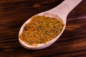 Mix of different seasonings in wooden spoon