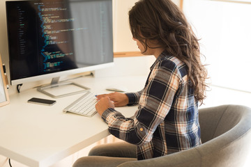 Woman programming computer