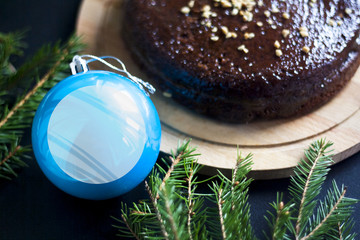Christmas cake. Chocolate cake with nuts. A blue ball.