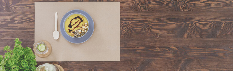 Pumpkin soup on wooden table