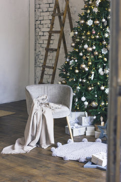 Big beautiful Christmas tree is decorated with Scandinavian interior