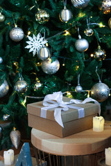 Gift box near Christmas tree