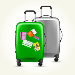 Wheeled suitcases with travel tags - silver and green baggage