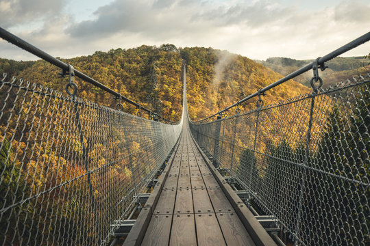 Fototapeta Geierlay Suspension Bridge against cloudy sky in autumn, Moersdorf, Germany