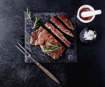 Steak on slate board with herbs