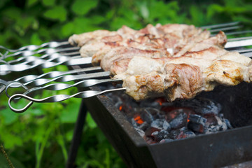 Chicken grilling on the brazier. Selective focus.