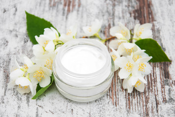 Fototapeta na wymiar Moisturizing cream with jasmine flowers