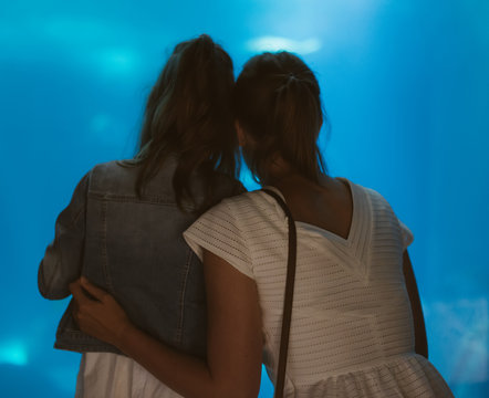 Woman and her daughter in the aquarium.
