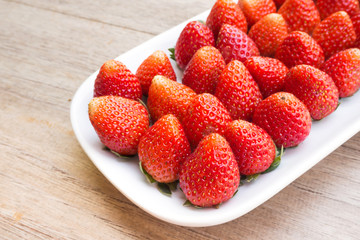 Fresh strawberry on white plate. Sweet taste.