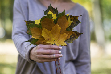 Woman Holding A Bunch of Leaves in Front of Her Face