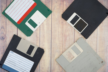 Old diskettes on a wooden pallet background