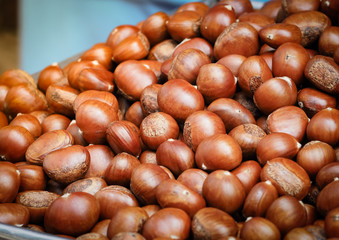 Chestnuts (Sterculia monosperma) roasting. Selective focus 