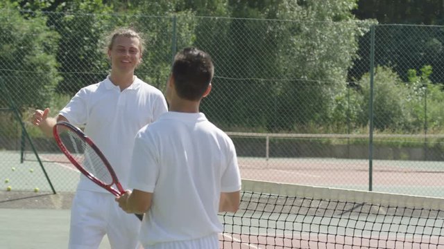  Male tennis player takes a break from game to get his breath back