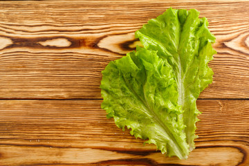 fresh lettuce leaves on a wooden board