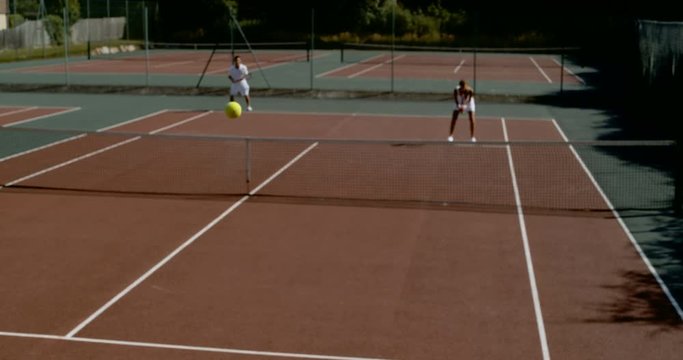  Tennis match in progress with ball traveling through the air in super slowmo