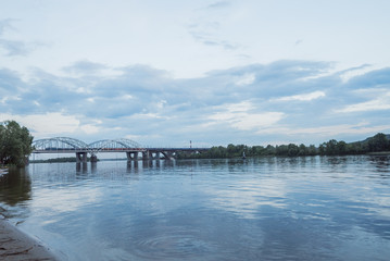 Fototapeta na wymiar Reflection of bridge and sky on river