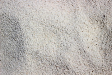 White solid sand background. Sealed white sand on the beach. View from above. Can be used as a background.  Artistic texture for marine themes. 