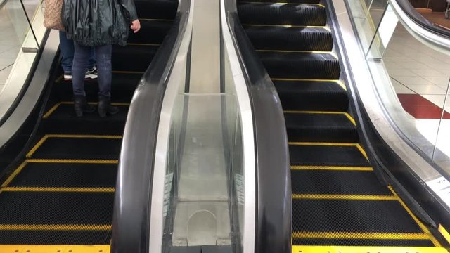 Cinemagraph people using escalator. Shopping concept. Copy space     