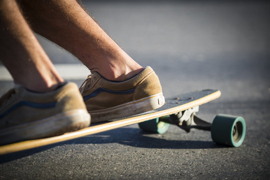 Close-up view of a skater cruising along the street on his Skateboard