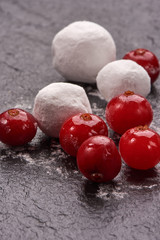 Cranberry in sugar on black stone board