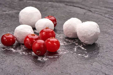 Cranberry in sugar on black stone board