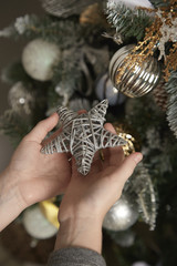 A child is holding a Christmas star