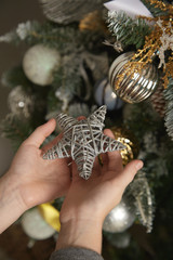 A child is holding a Christmas star