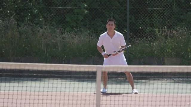  Male tennis players enjoying a game on outdoor court in the summer