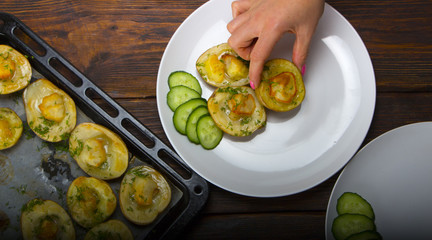 baked potatoes in a baking sheet on a wooden table top view