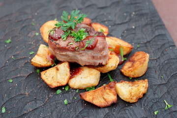 Tenderloin steak and fried potatoes with bbq sauce and chopped parsley