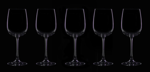 Silhouette of wineglass with violet illumination